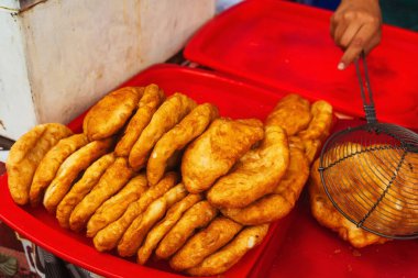 fried dough in the canteen of Tashkent. Deep-fried pies with potatoes at the Uzbek bazaar. national fast food of uzbekistan butter dough with stuffing