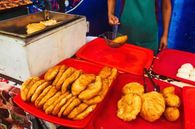 fried dough in the canteen of Tashkent. Deep-fried pies with potatoes at the Uzbek bazaar. national fast food of uzbekistan butter dough with stuffing