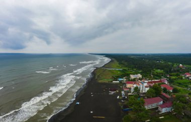 healing black sand beach in georgia. Magnetic sand on the beach in Magnetiti Batumi. High waves in the black Georgian sea in the village of Ureki