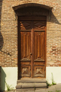old brick building on the main street of tbilisi. abandoned school in georgia. baked brick building