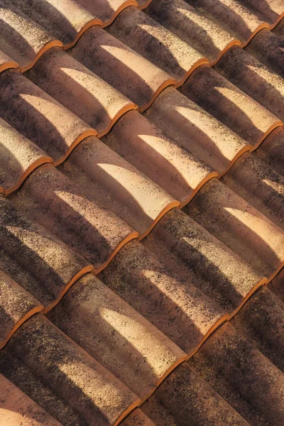 old roof tiles on the roof of a house in georgia. Eco-friendly clay tile rainproof