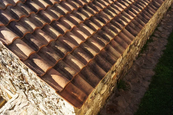 old roof tiles on the roof of a house in georgia. Eco-friendly clay tile rainproof