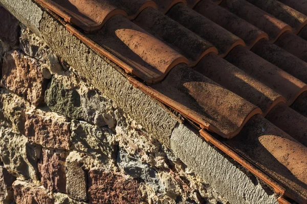 old roof tiles on the roof of a house in georgia. Eco-friendly clay tile rainproof