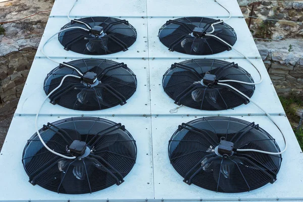 building cooling unit. fans for indoor exhaust operation. black ventilation vanes