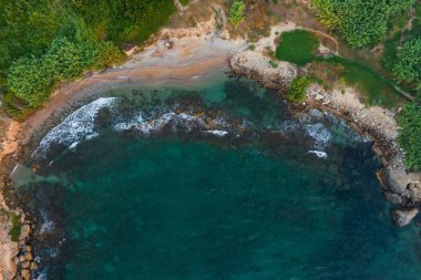 rocky coast of turkish cyprus. clean water on the island of cyprus. beautiful but problematic rocky beaches in cyprus. drone photo of blue sea and brown rocky beach