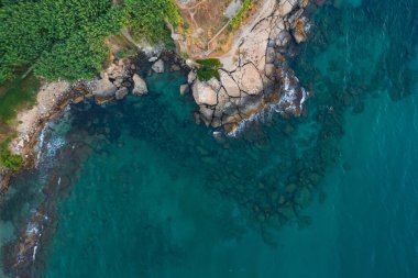 rocky coast of turkish cyprus. clean water on the island of cyprus. beautiful but problematic rocky beaches in cyprus. drone photo of blue sea and brown rocky beach