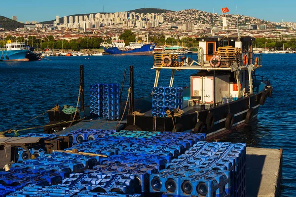 delivery of drinking water to the island in istanbul. replenishment of provisions and water by sea. storage of clean bottled water on the pier. waiting for food and water to be loaded onto the ship
