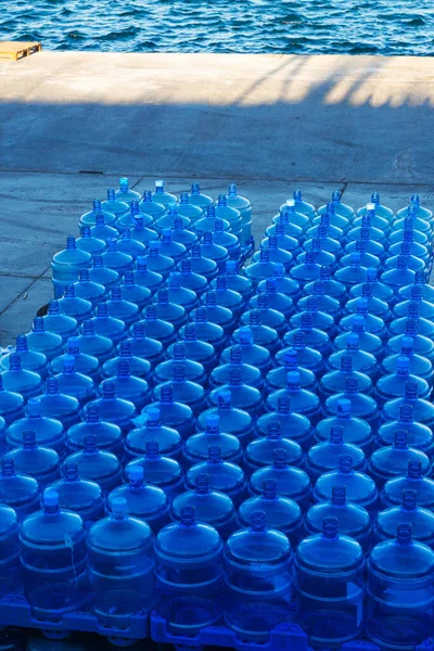 delivery of drinking water to the island in istanbul. replenishment of provisions and water by sea. storage of clean bottled water on the pier. waiting for food and water to be loaded onto the ship