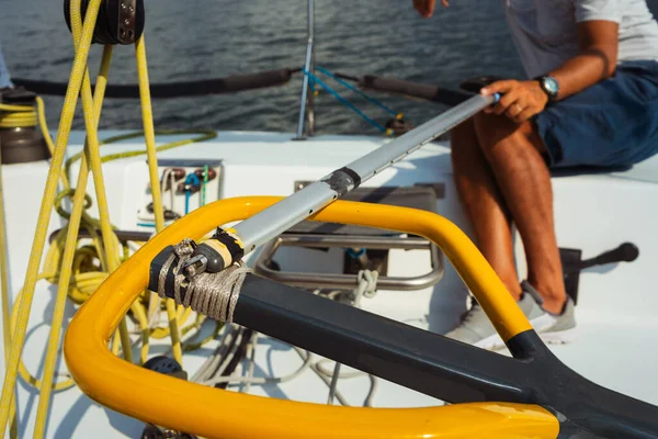 beginner courses for men on a sailing yacht. a man controls the steering wheel on a speedboat. professional sailing yacht management