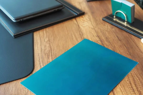 dark blue office folders on a wooden table in istanbul. folders for collecting documents in the office for the sale of real estate in Turkey. paper covers for printed documents