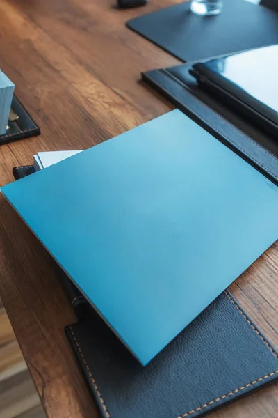 dark blue office folders on a wooden table in istanbul. folders for collecting documents in the office for the sale of real estate in Turkey. paper covers for printed documents