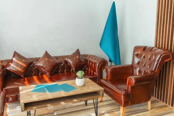 brown leather sofa in turkey office. place for receiving clients in the office. seating area with sofa
