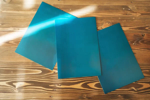 dark blue office folders on a wooden table in istanbul. folders for collecting documents in the office for the sale of real estate in Turkey. paper covers for printed documents