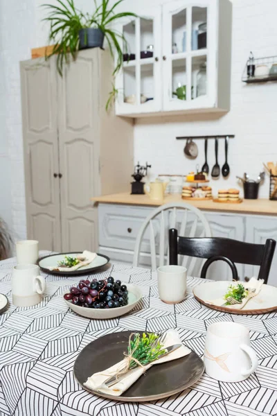 kitchen room in the photo studio. dining table against the background of a kitchen cabinet and bedside tables. table setting with a tablecloth for a photo shoot