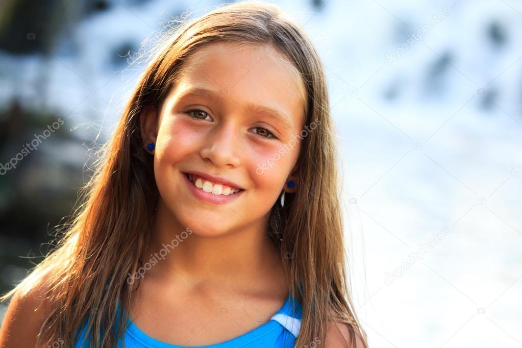 Young girl posing in sunshine at River's edge.