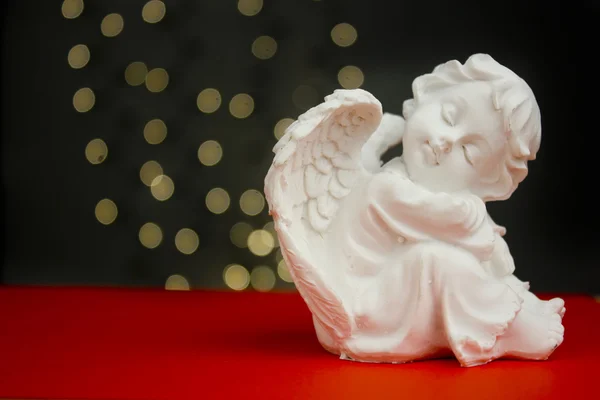 arka plan üzerinde kırmızı ışıklar ile Noel meleği