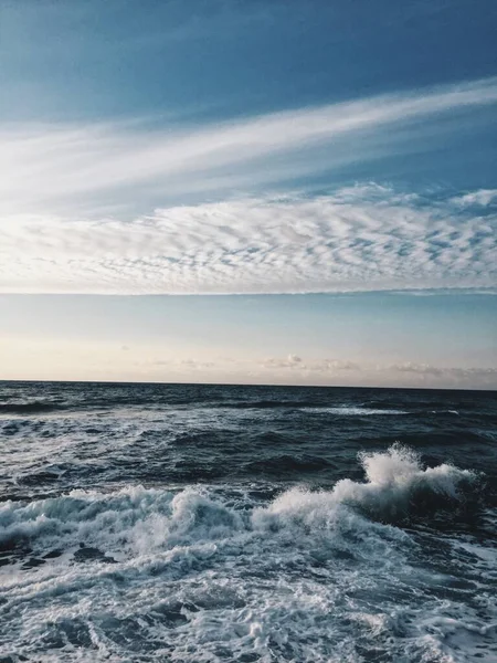 Blauwe zee golf met wit schuim en lucht op de achtergrond — Stockfoto
