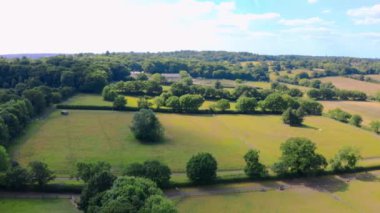 Aerial top down view from the drone on the narrow passageway leading to a small chapel. Chapel located in a big green open area of fields near Rosary Manor, Mill Hill, North West London, London, UK.