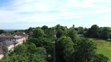 Aerial top down view from the drone on the narrow passageway leading to a small chapel. Chapel located in a big green open area of fields near Rosary Manor, Mill Hill, North West London, London, UK.