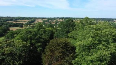 Aerial top down view from the drone on the narrow passageway leading to a small chapel. Chapel located in a big green open area of fields near Rosary Manor, Mill Hill, North West London, London, UK.