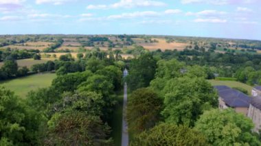 Aerial top down view from the drone on the narrow passageway leading to a small chapel. Chapel located in a big green open area of fields near Rosary Manor, Mill Hill, North West London, London, UK.