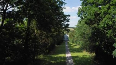 Aerial top down view from the drone on the narrow passageway leading to a small chapel. Chapel located in a big green open area of fields near Rosary Manor, Mill Hill, North West London, London, UK.