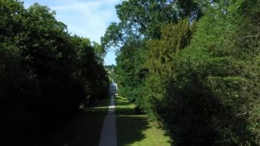 Aerial top down view from the drone on the narrow passageway leading to a small chapel. Chapel located in a big green open area of fields near Rosary Manor, Mill Hill, North West London, London, UK.