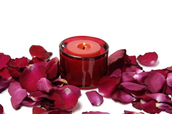 Petals and red candle — Stock Photo, Image