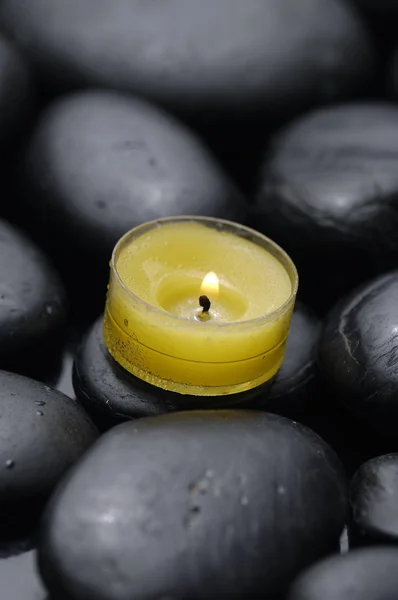 Candle and pebbles — Stock Photo, Image