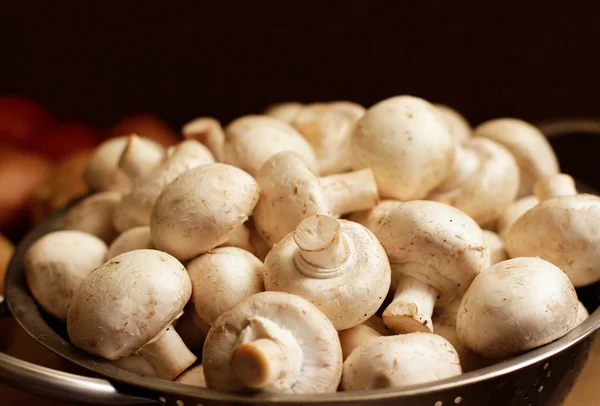Fresh mushrooms in colander — Stock Photo, Image