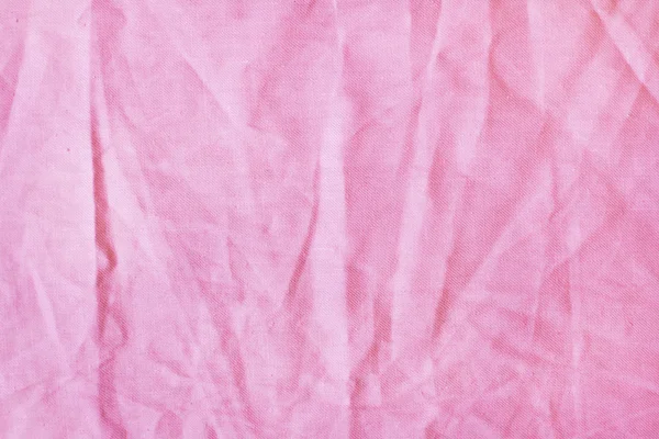 Смятая розовая ткань на заднем плане — стоковое фото