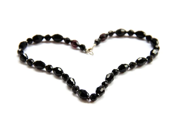 Heart from black beads on white background — Stock Photo, Image