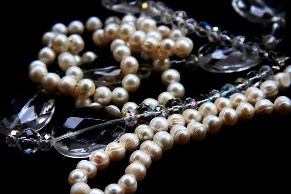 Pearls and crystals on black background — Stock Photo, Image