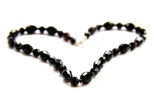 Heart from black beads on white background — Stock Photo, Image