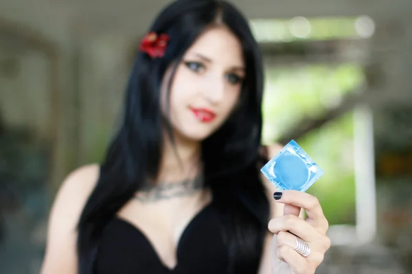 Condom in the girl's hand — Stock Photo, Image