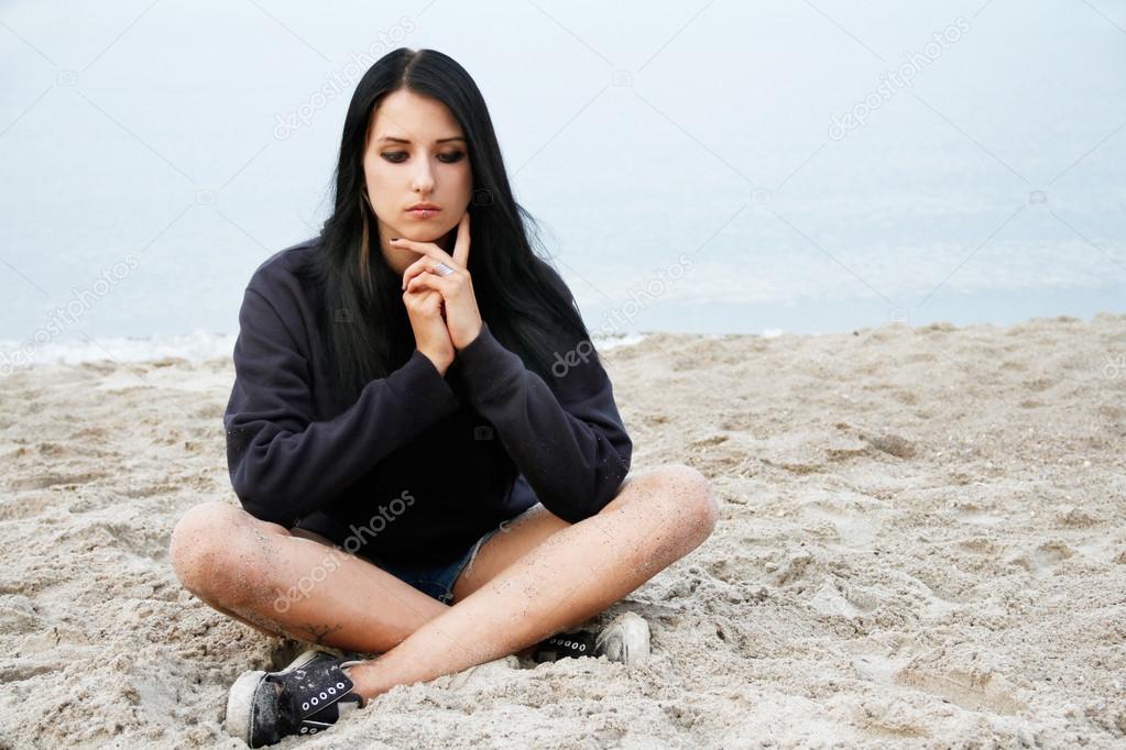Girl sitting on the beach