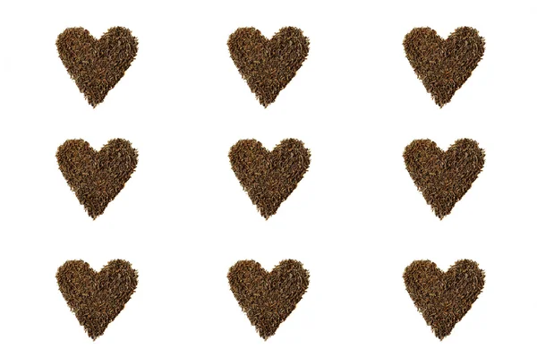 Tea leaves in the shape of hearts on white background — Stock Photo, Image