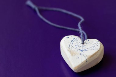 Wooden heart close-up on blue background