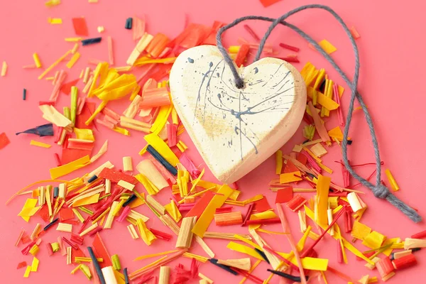 Heart and colored confetti close-up on pink background — Stock Photo, Image