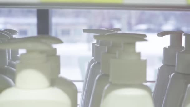 Plastic bottles with hygienic liquid dispensers in a row — Stock Video