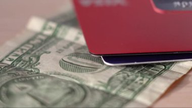 Plastic credit bank cards over a dollar bill