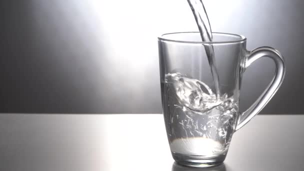Versare l'acqua in una tazza di vetro — Video Stock