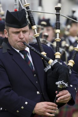 Piper at the Cowal Gathering Highland Games in Scotland clipart