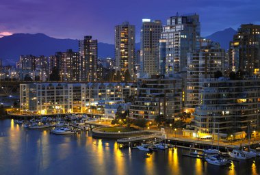 Yaletown waterfront and False Creek by night. City of Vancouver in British Columbia in Western Canada. clipart