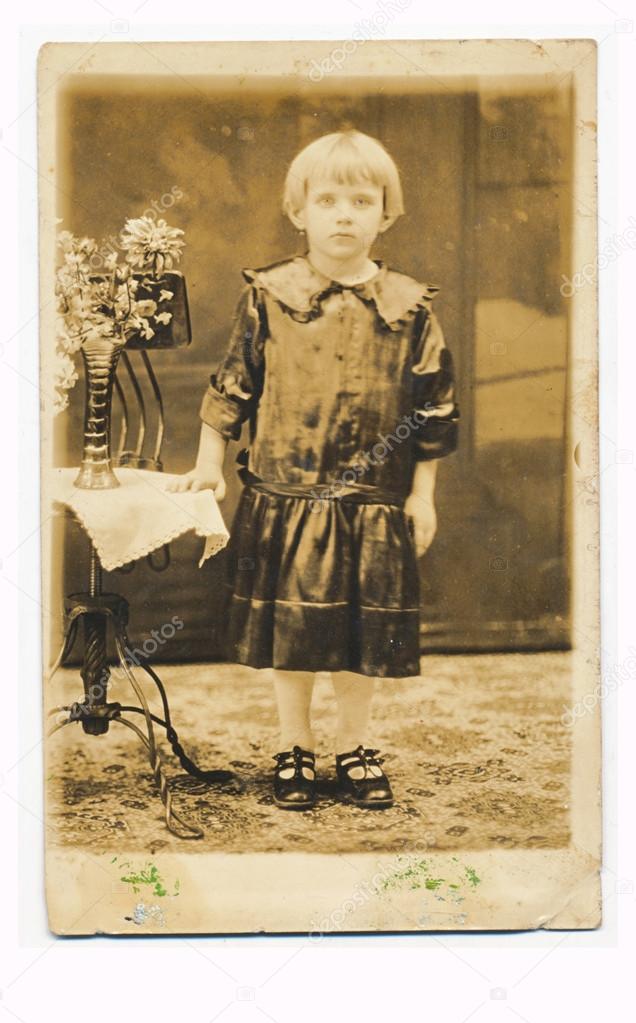 Girl posing next to flowers