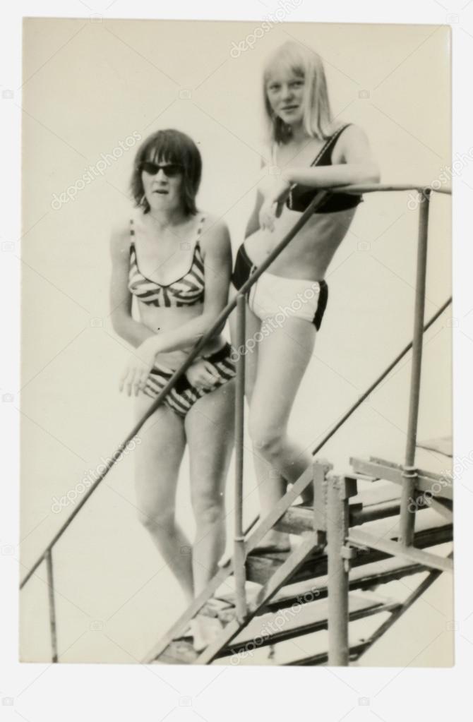 Friends - two young women at the swimming pool