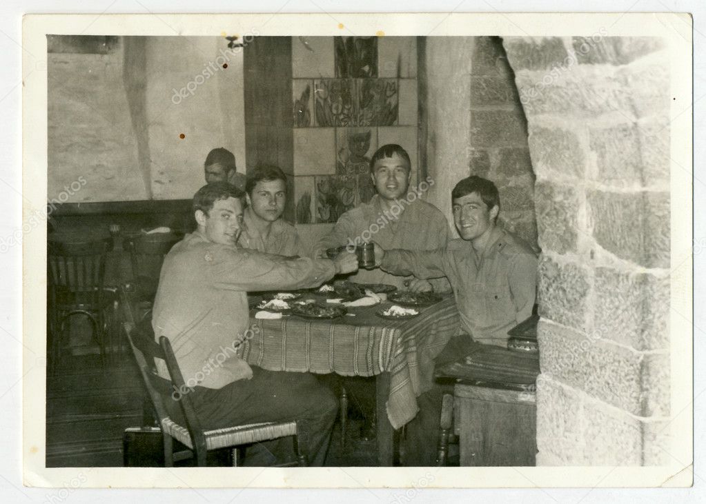 Soldiers sitting in a village pub