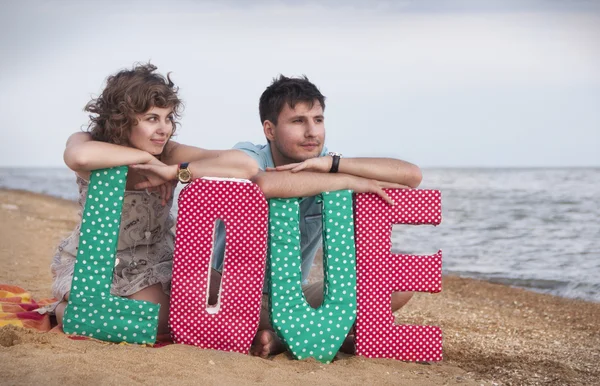 Boy and girl on the beach Stock Picture