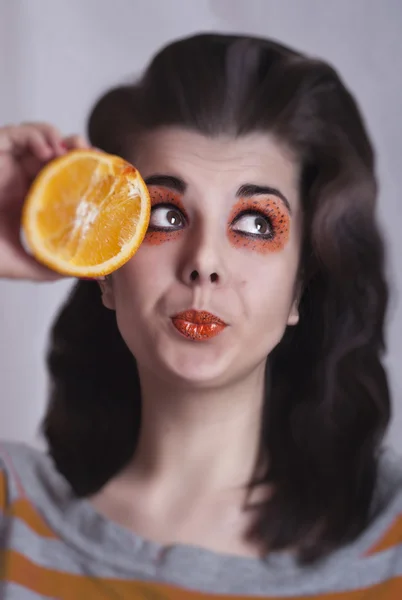 Portrait of young girl with orange — Stock Photo, Image