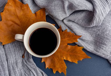 Sarı yapraklı arka planda bir fincan kahve.